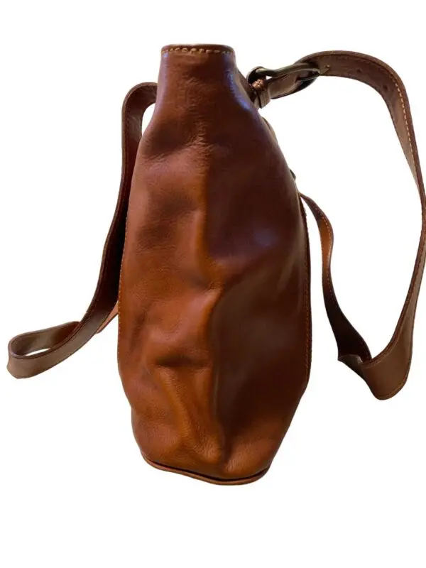 Side view of a leather bag in brown color